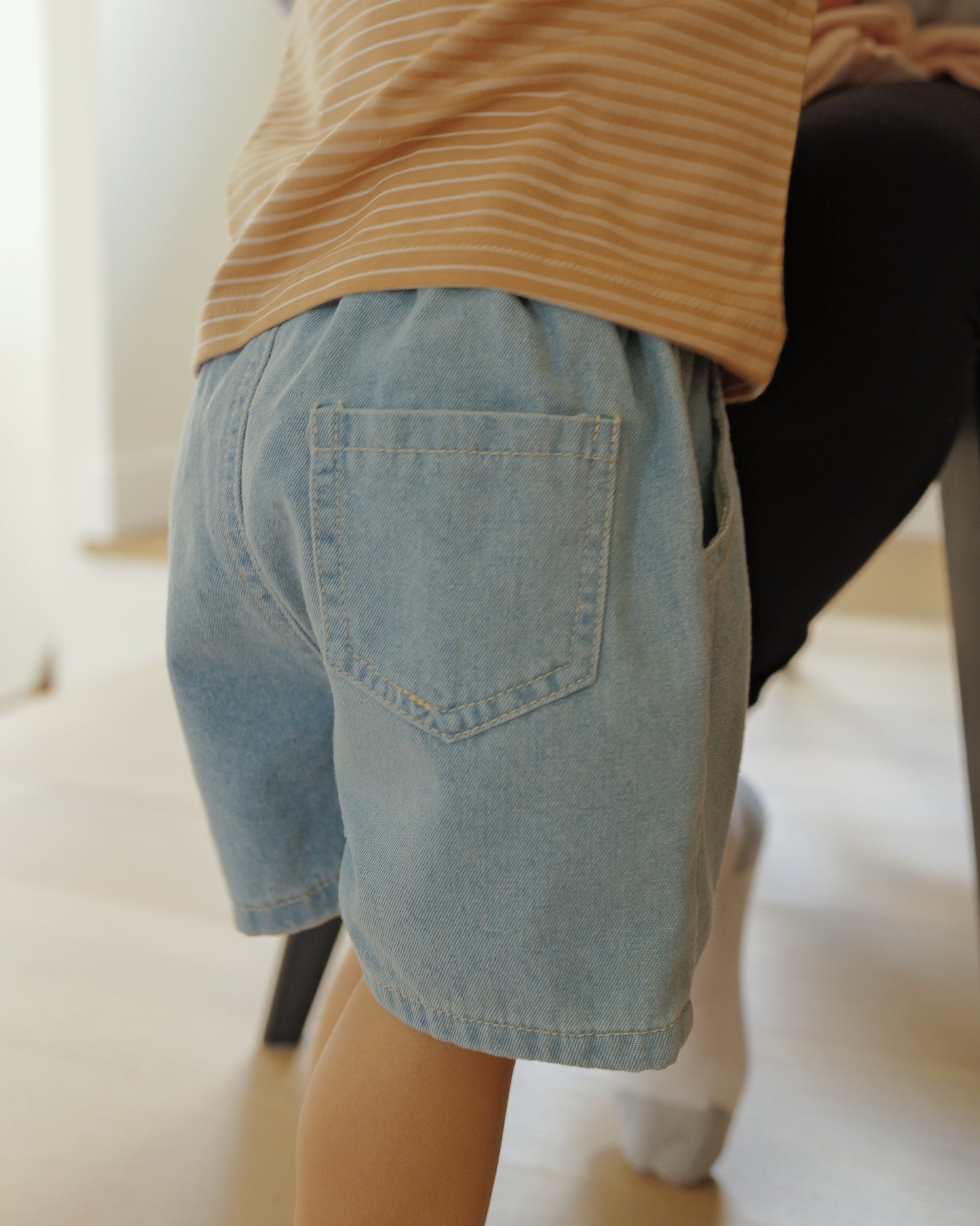 back of light blue denim shorts