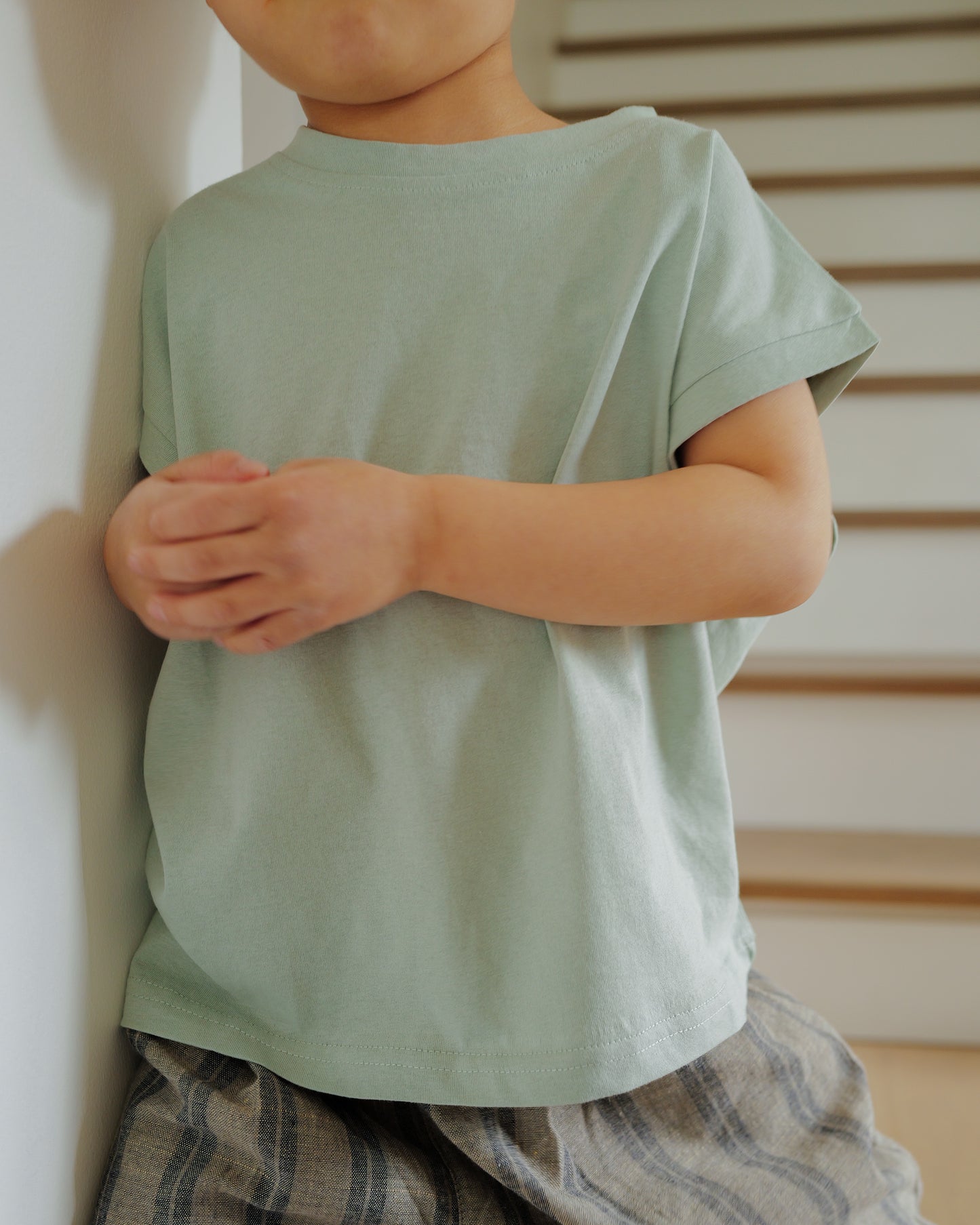 boy in cut off tee sage