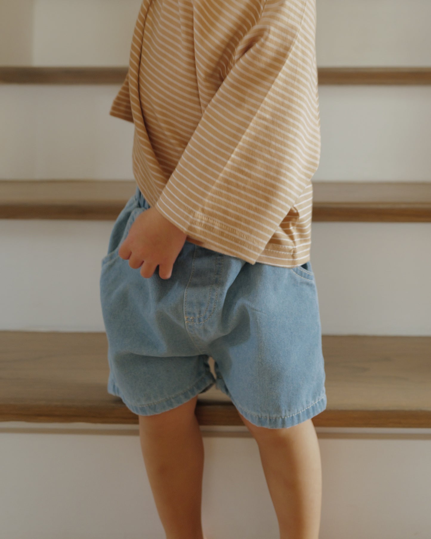 boy in light blue denim shorts