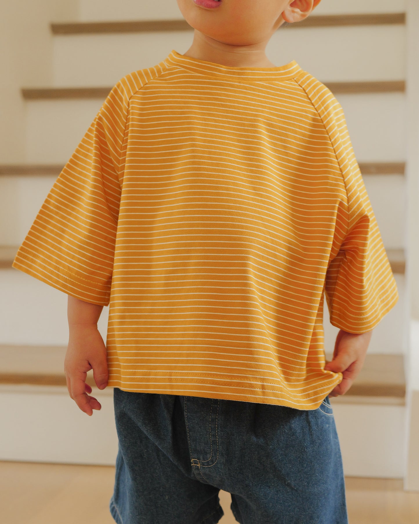 boy in pin striped tee mustard