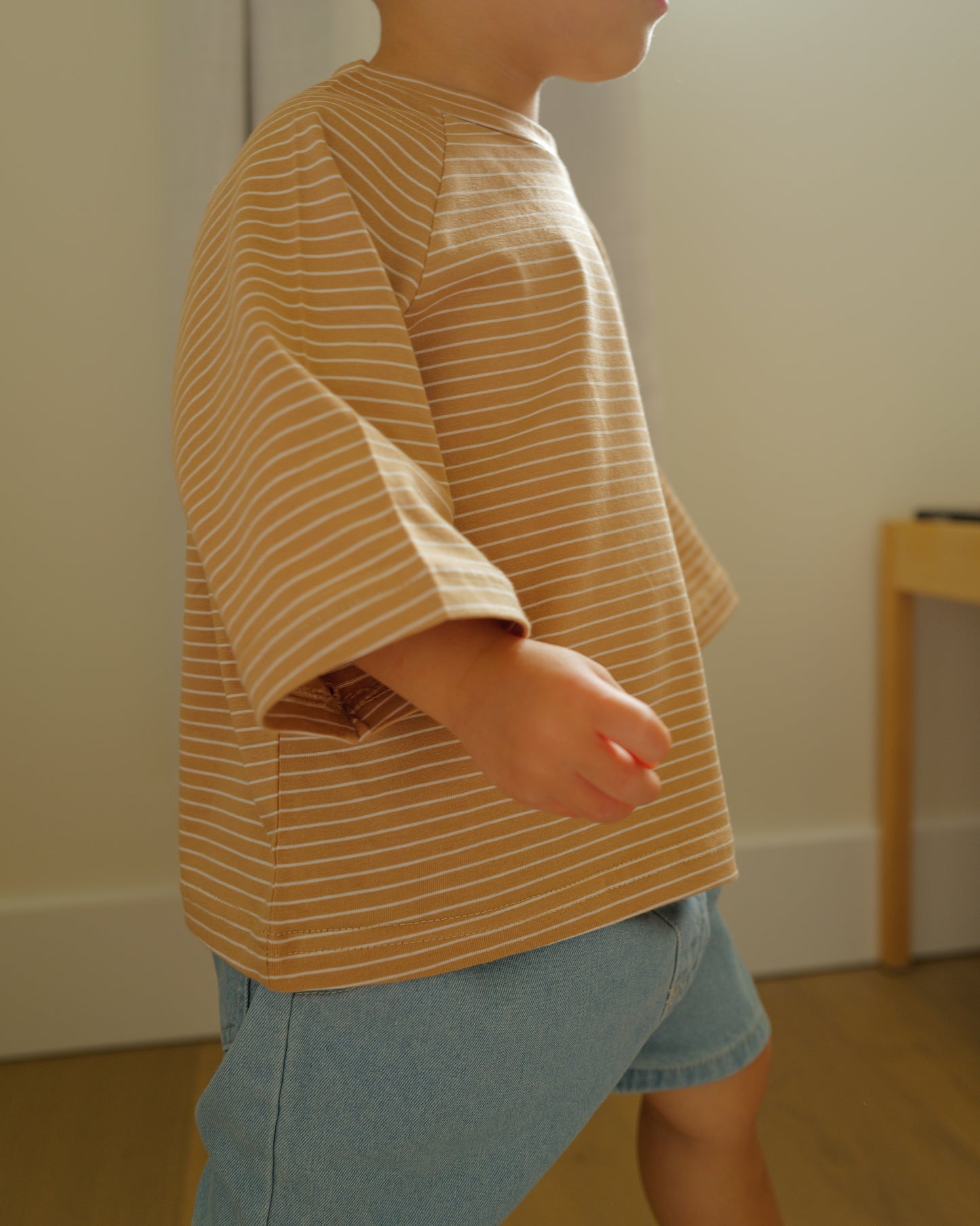 boy wearing pin striped tee khaki
