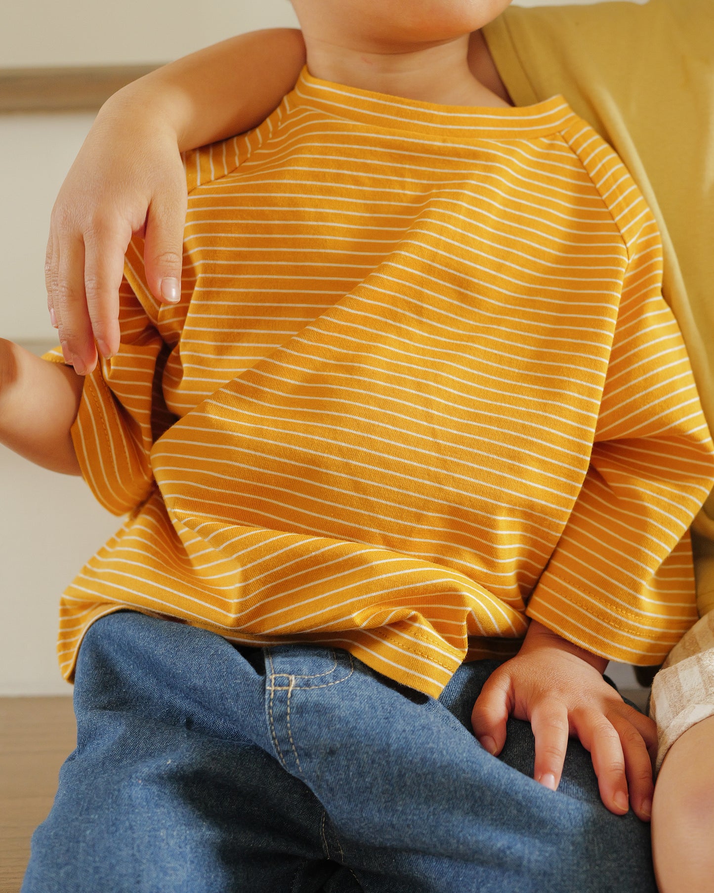 boy wearing pin striped tee mustard