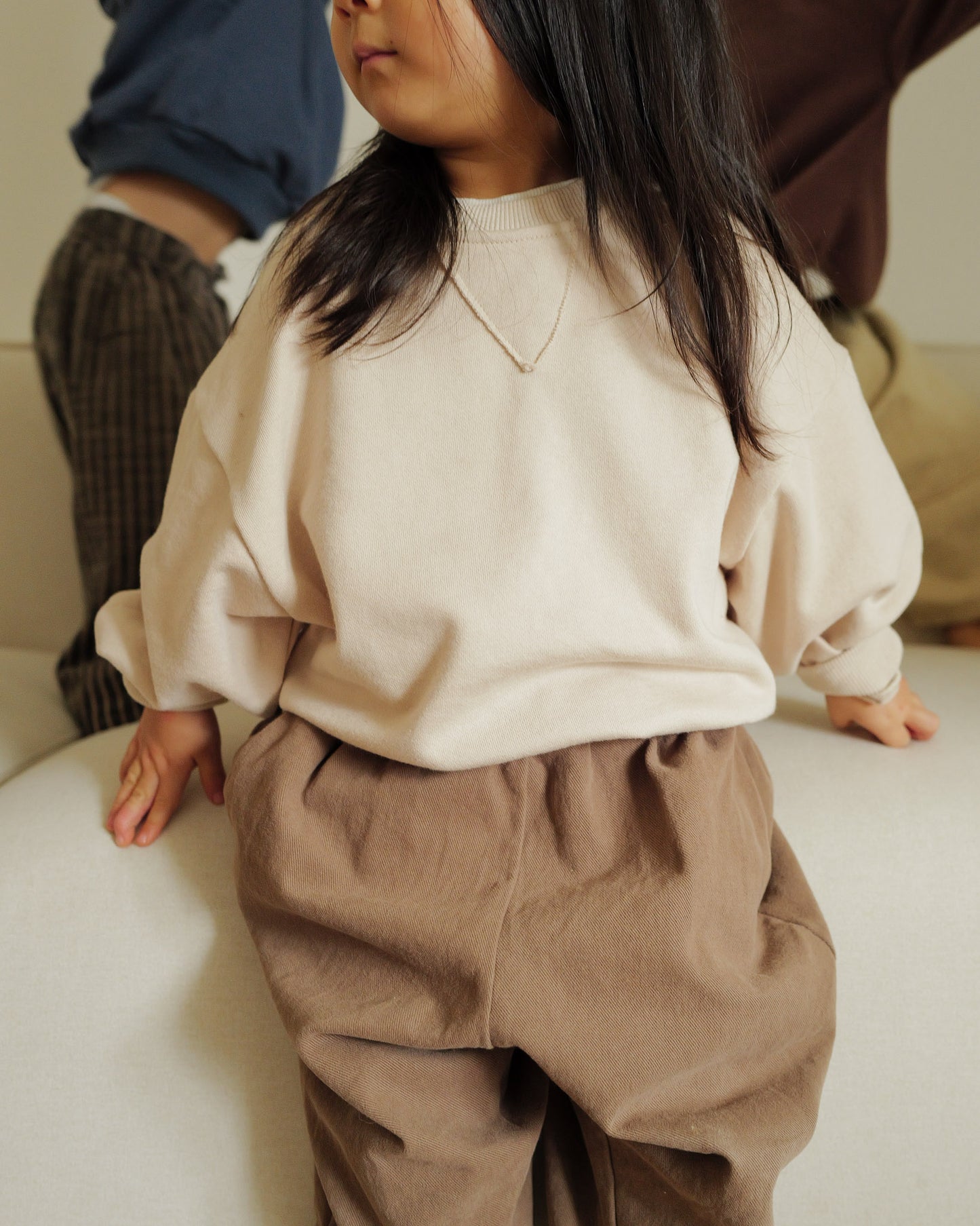 3 year old girl wearing oori noa baggy crew sweatshirt