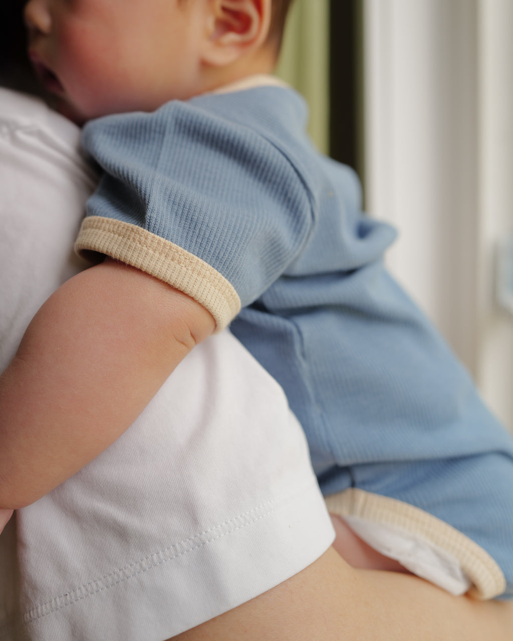 detail of ribbed short-sleeve onesie blue