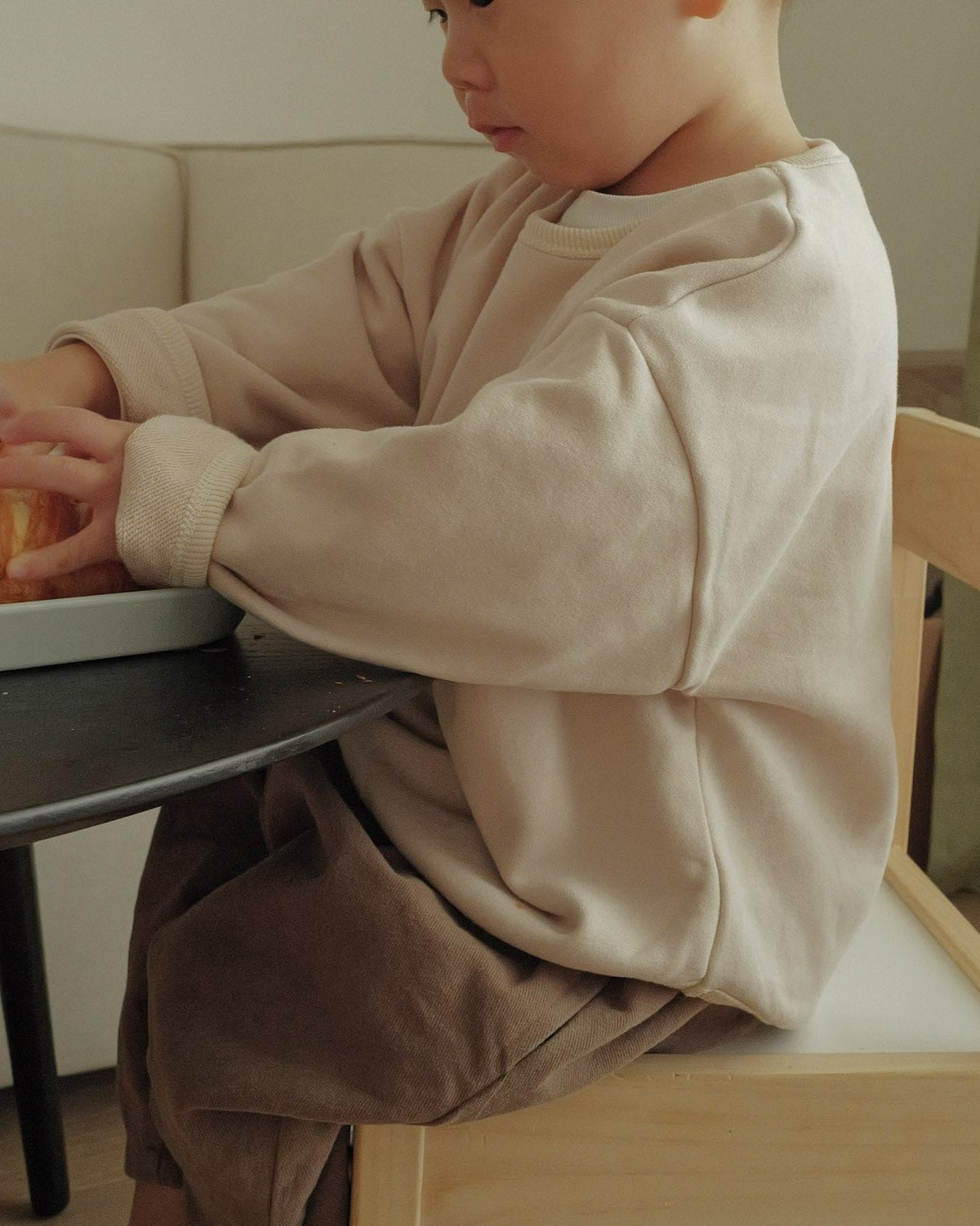 toddler boy sitting wearing crewneck sweater