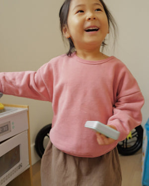 girl in mauve crewneck sweater